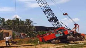 Thi công đường cao tốc, xe cần cẩu ngã đè nhà dân