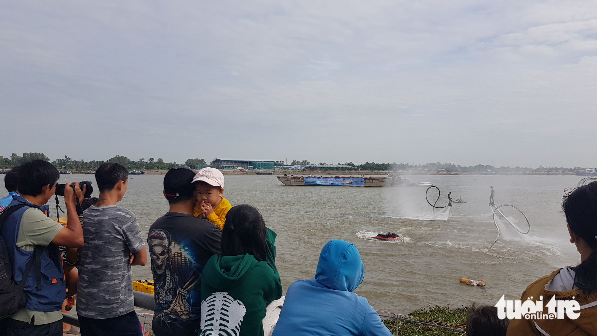 Người dân chen kín bờ kè sông Tiền xem flyboard, dù lượn - Ảnh 4. Người dân chen kín bờ kè sông Tiền xem flyboard, dù lượn - Ảnh 4.