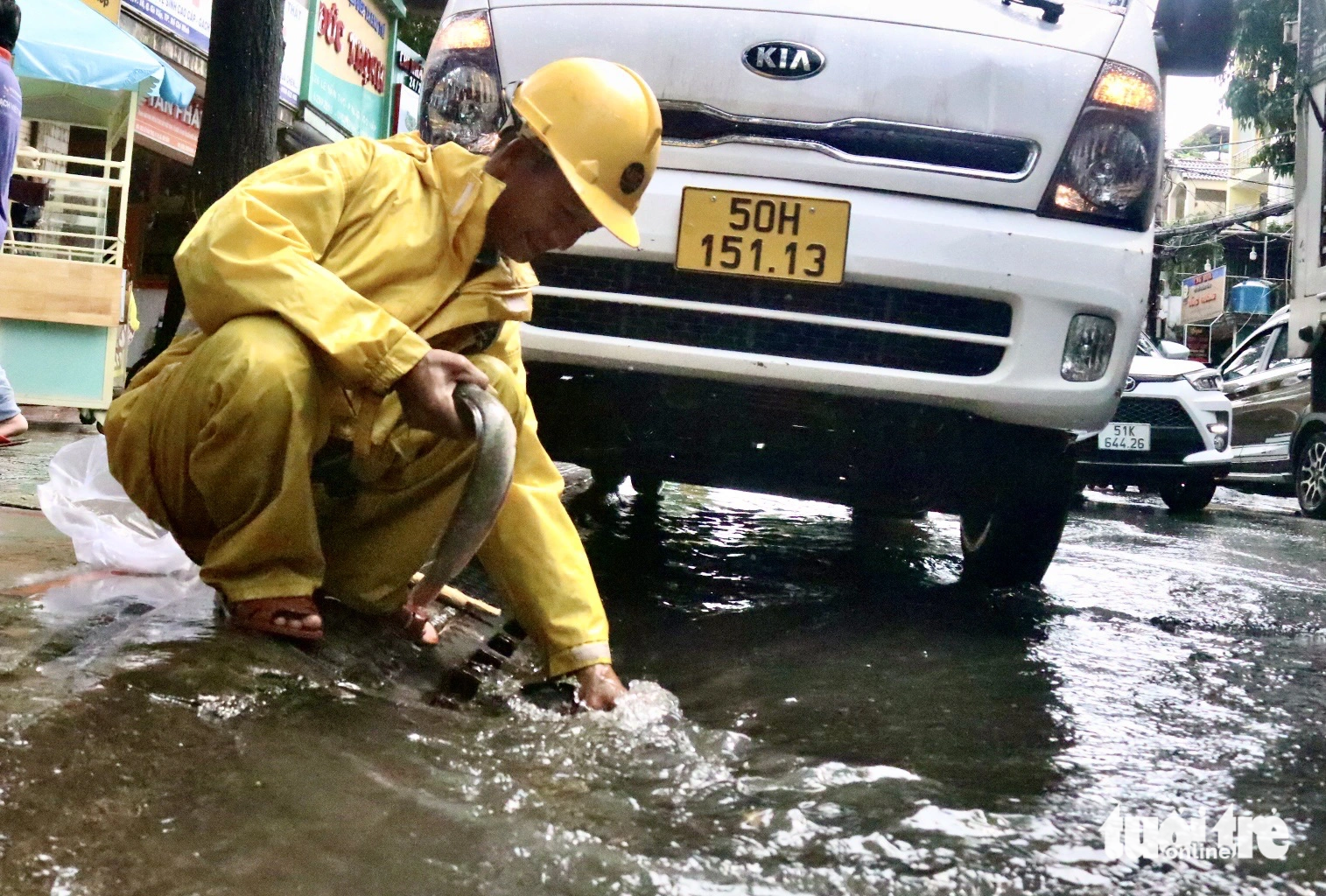Mưa lớn, nhân viên thoát nước bắt được cá bơi trên đường Lê Văn Thọ (quận Gò Vấp)