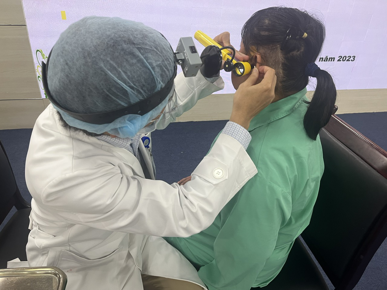 Lấy một phần chiếc đũa bị "bỏ quên" trong tai bệnh nhân trong hơn 7 năm - Ảnh 1. Bác sĩ Bệnh viện Tai mũi họng đang khám tai cho bệnh nhân để quên một phần chiếc đũa trong tai hơn 7 năm- Ảnh: T.DƯƠNG