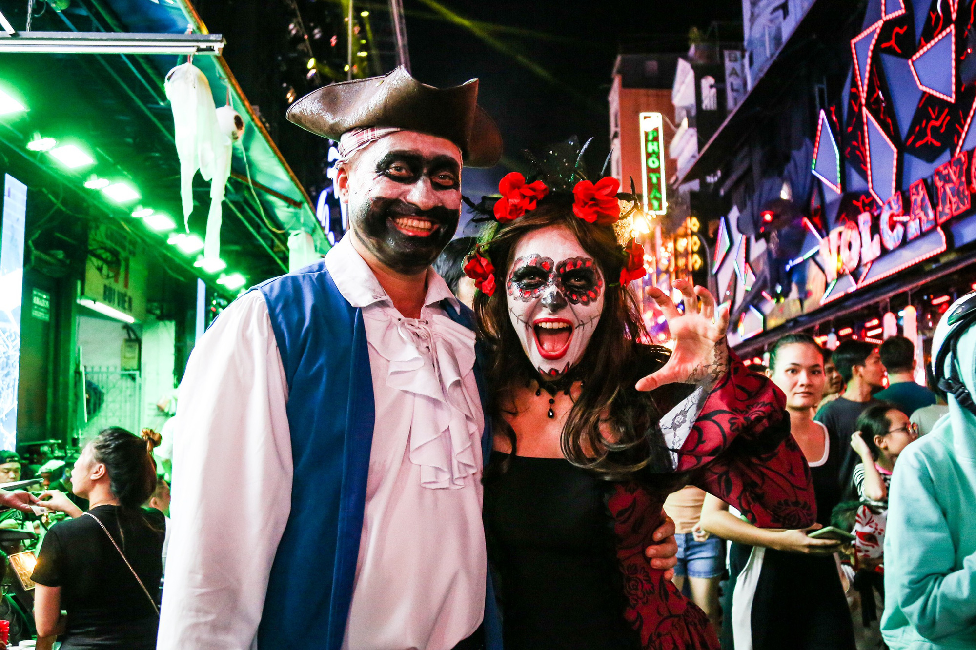 Two tourists from Moscow (Russia) enjoying the warm atmosphere of the Halloween celebration on Bui Vien Street (District 1). 