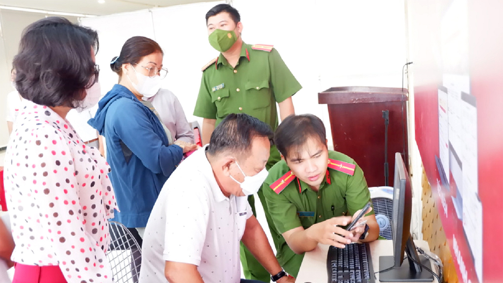 Đội tình nguyện trẻ hỗ trợ người dân sử dụng dịch vụ công trực tuyến tại quận 5 (TP.HCM) - Ảnh: K.ANH