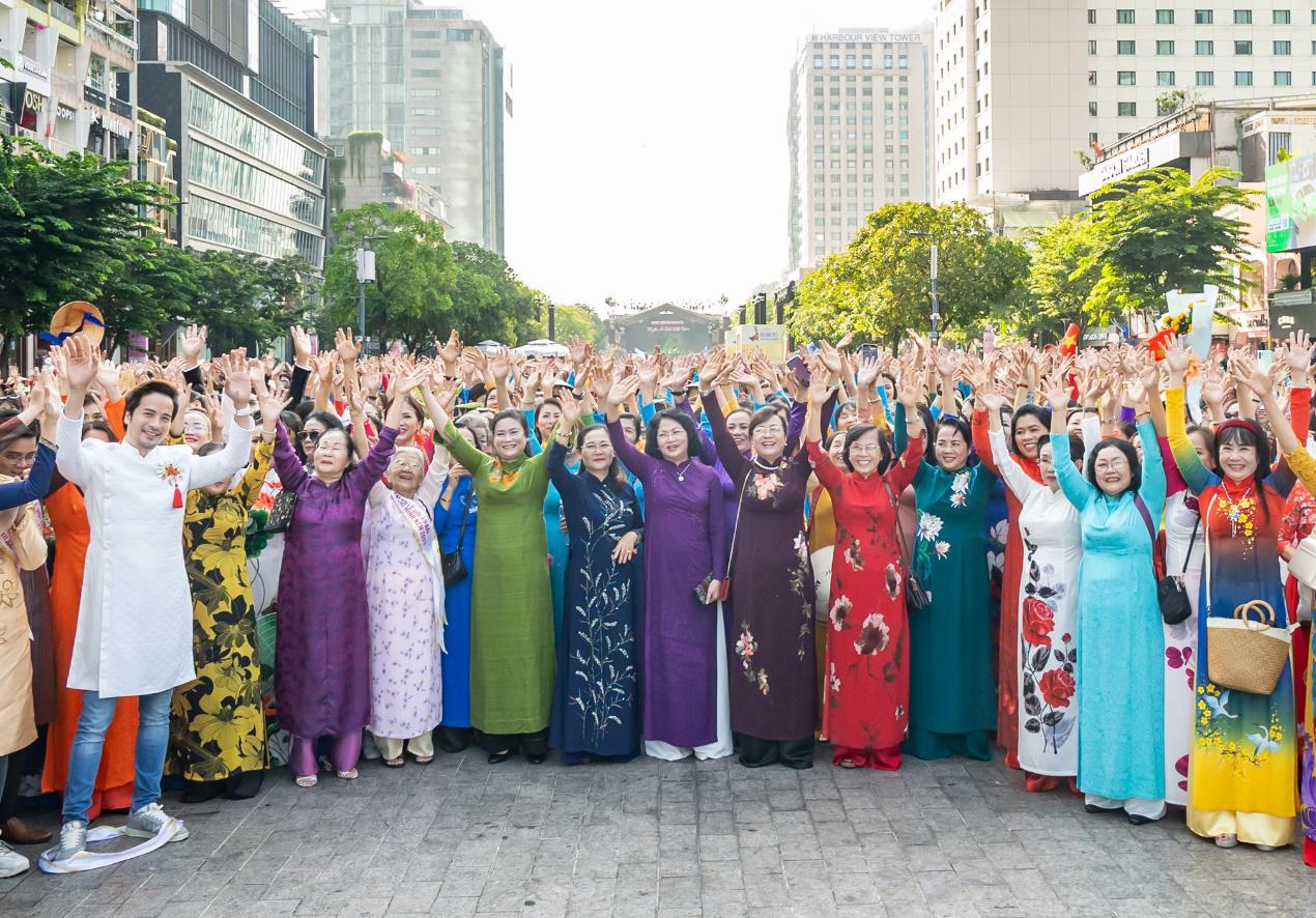 Tourists wearing Ao dai, which may be provided through Vietnam package tour