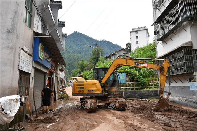 Khắc phục hậu quả mưa lớn tại khu tự trị dân tộc Miêu - Thổ gia Tương Tây, Trung Quốc ngày 2-7 - Ảnh: THX/TTXVN
