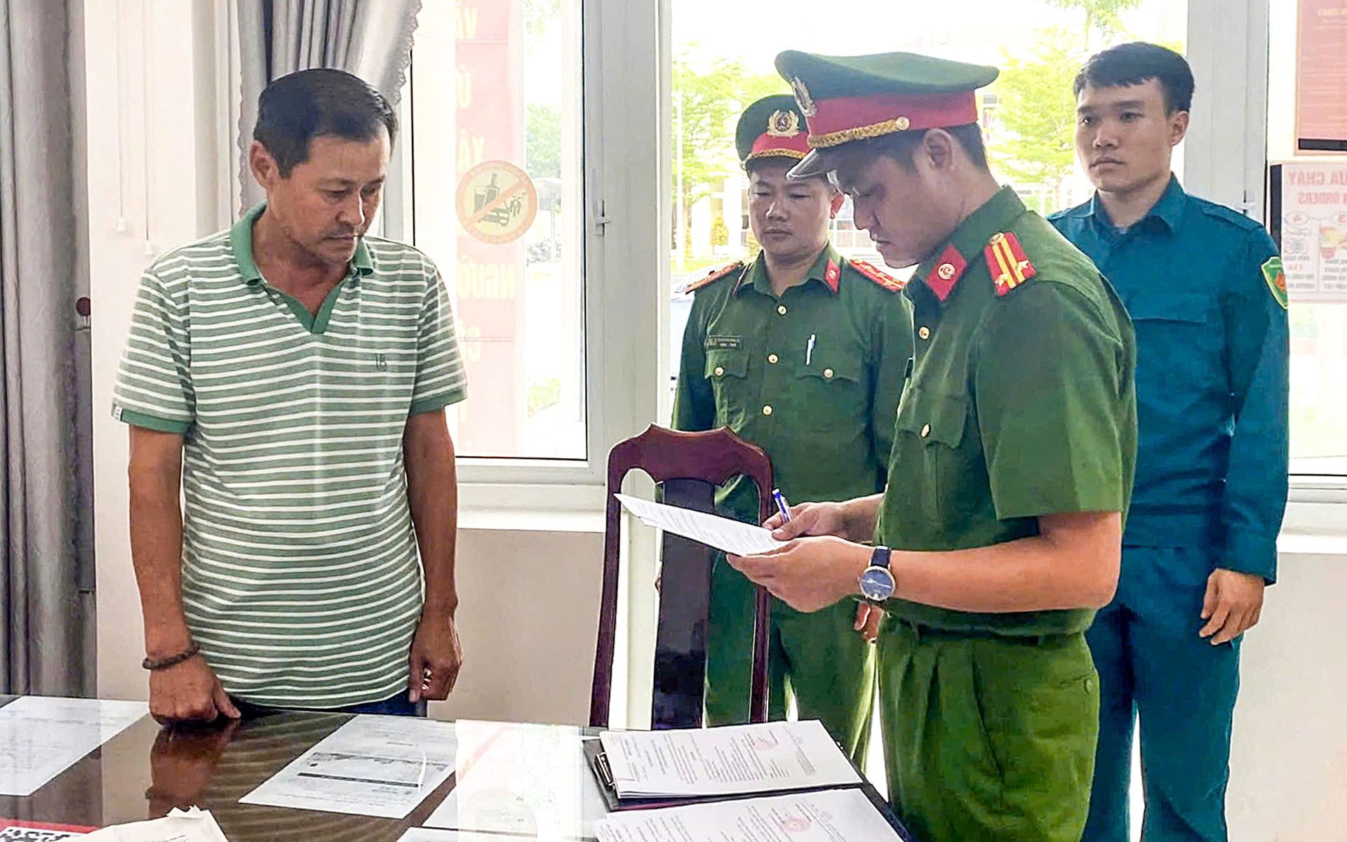 Cơ quan cảnh sát điều tra đọc quyết định khởi tố, lệnh bắt tạm giam Võ Đức Bảy, nguyên phó giám đốc Ngân hàng Việt Á, chi nhánh Hội An - Ảnh: TRANG PHƯƠNG