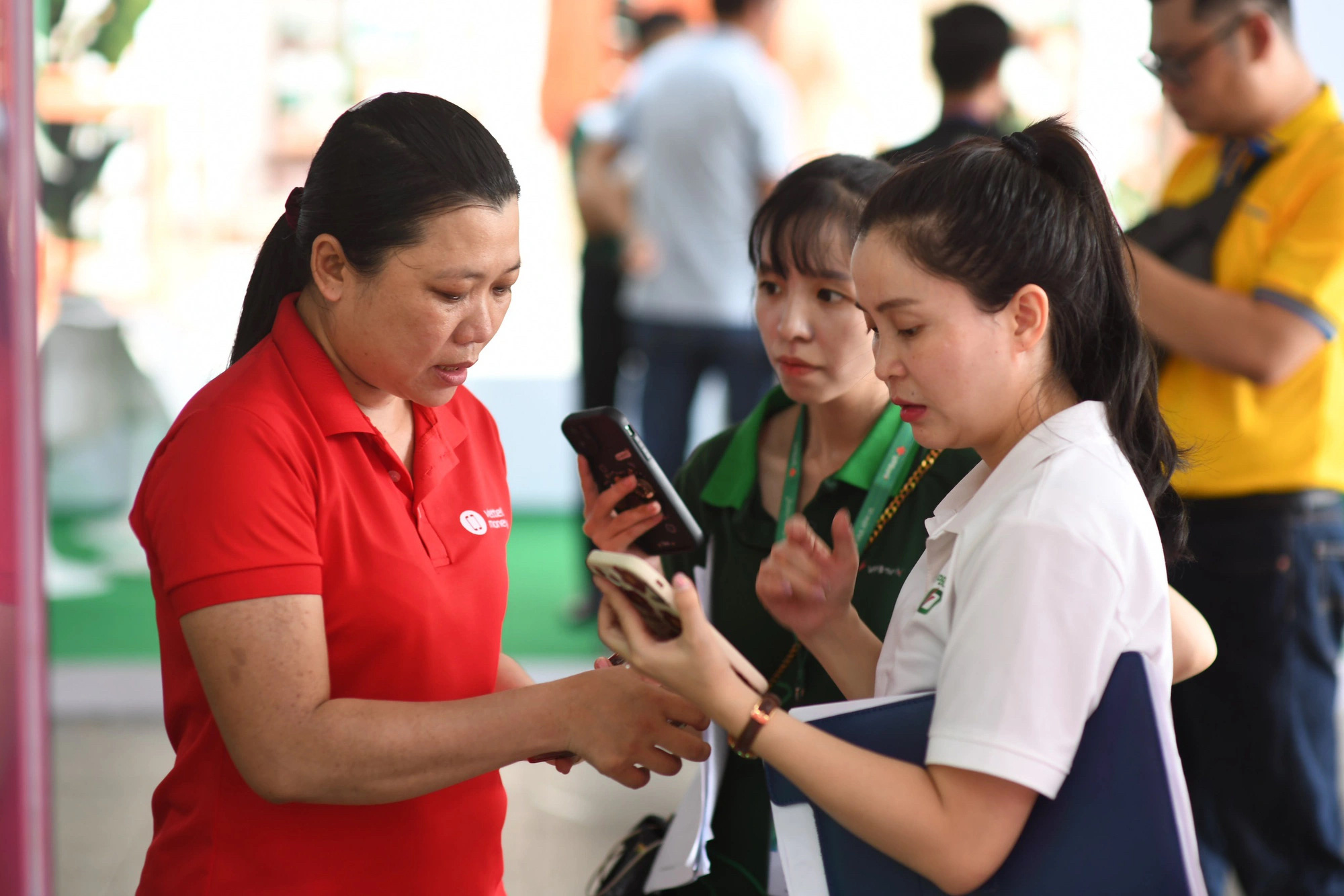 Nhân viên gian hàng Viettel Money nhiệt tình tư vấn ứng dụng thanh toán không tiền mặt trong Lễ hội Không tiền mặt 2024 - Ảnh: QUANG ĐỊNH