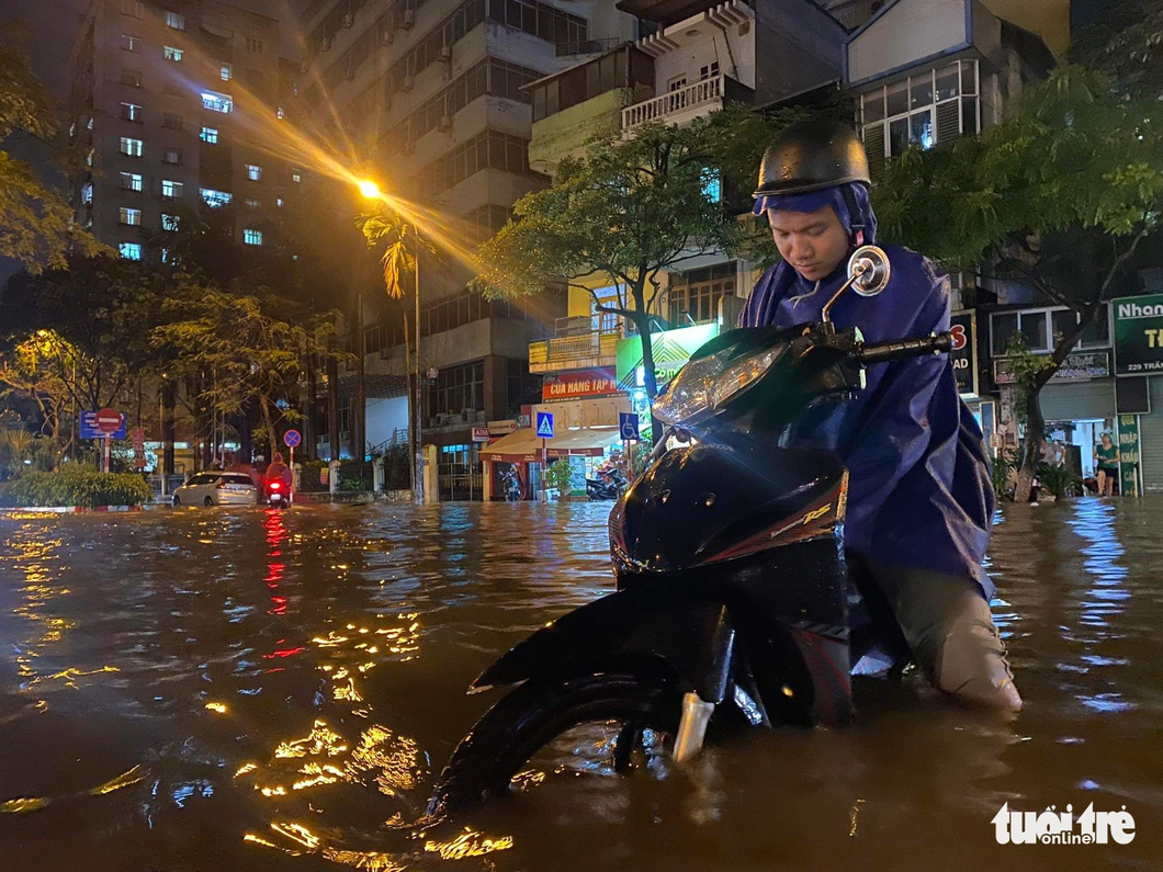 Hà Nội mưa chưa đầy 1 giờ, nhiều tuyến phố thành sông, nước tràn vào nhà dân - Ảnh 9.