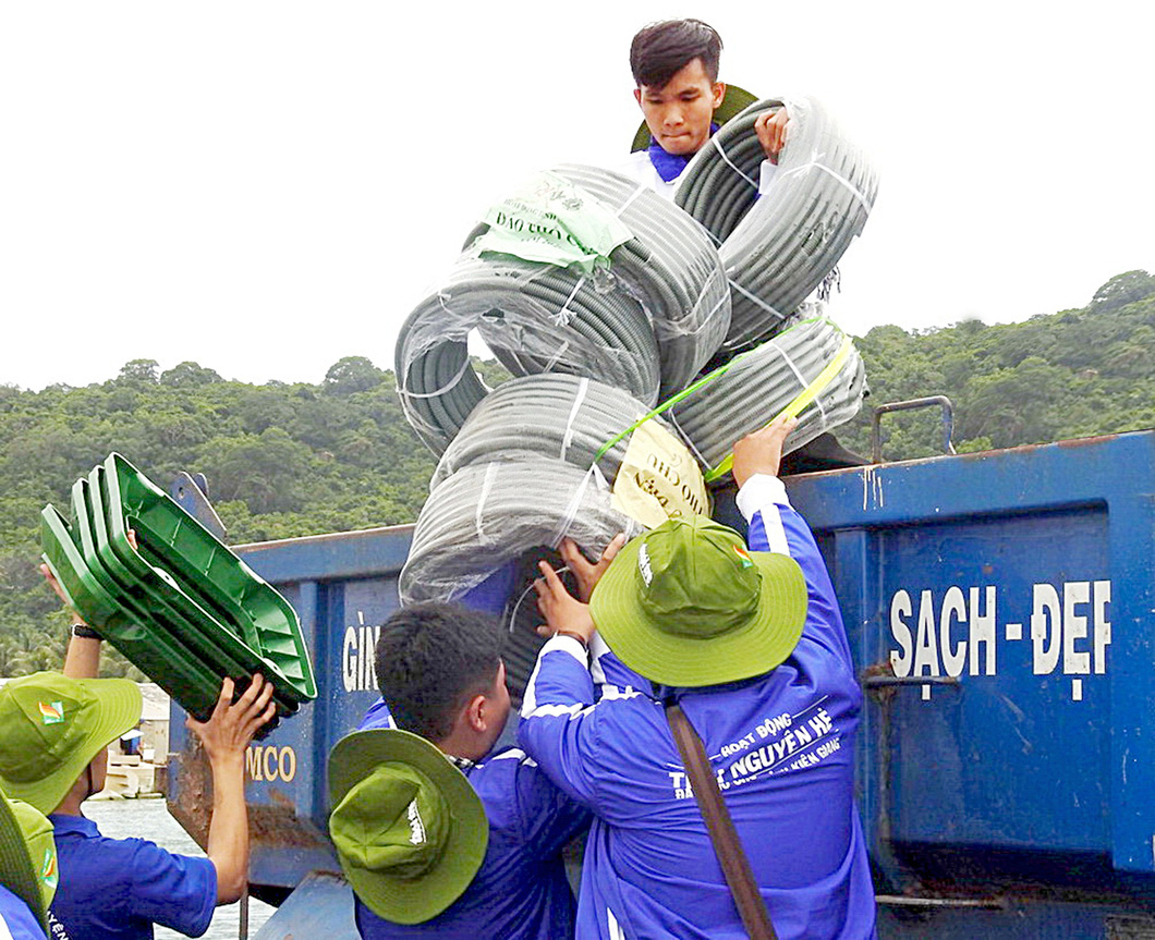 Các bạn trẻ tình nguyện TP.HCM chuyển vật dụng từ đất liền ra lắp tặng công trình cho bà con tại đảo Thổ Chu (Kiên Giang) trong chiến dịch Mùa hè xanh - Ảnh: Q.L.