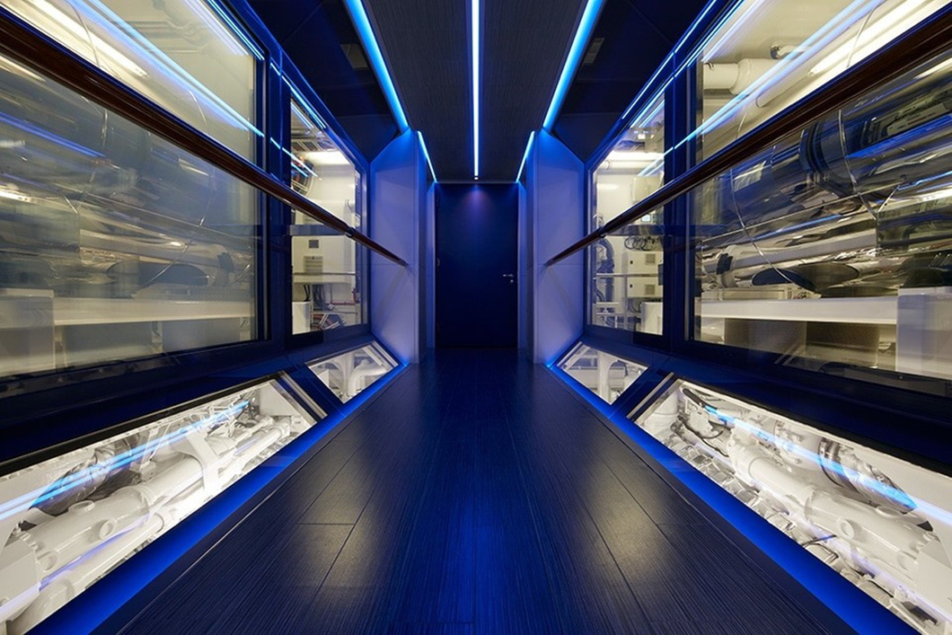 There's a beautiful corridor where guests can view the engine through large glass walls lit by blue LEDs - Photo: Feadship