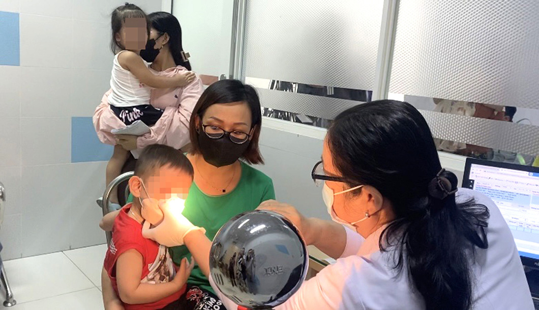 Phụ huynh đưa con đến Bệnh viện Nhi đồng 2 (TP.HCM) khám vì bị đau mắt đỏ - Ảnh: X.MAI