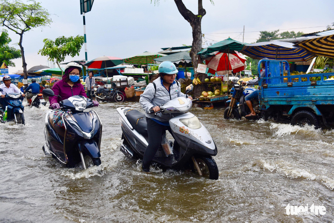 Triều cường lại lênh láng nhiều đường phố TP.HCM - Ảnh 4.