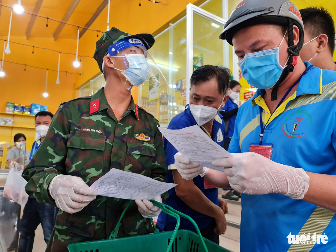 Cán bộ phường, tình nguyện viên cùng đi chợ hộ, mang thực phẩm đến tận nhà dân - Ảnh 10.