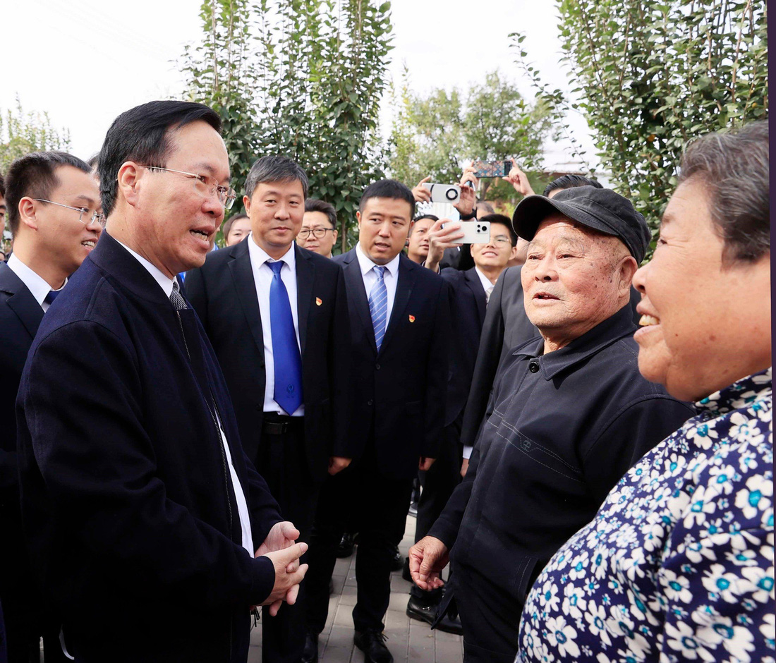 Chủ tịch nước trò chuyện với một số người dân thôn Tiểu Lỗ (Trung Quốc) - Ảnh: TTXVN