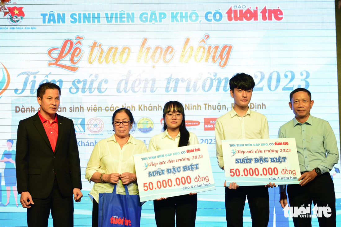 Hai tân sinh viên Ngô Thị Hồng Hạnh và Lê Văn Sỹ nhận suất học bổng đặc biệt 50 triệu đồng - Ảnh: DUYÊN PHAN