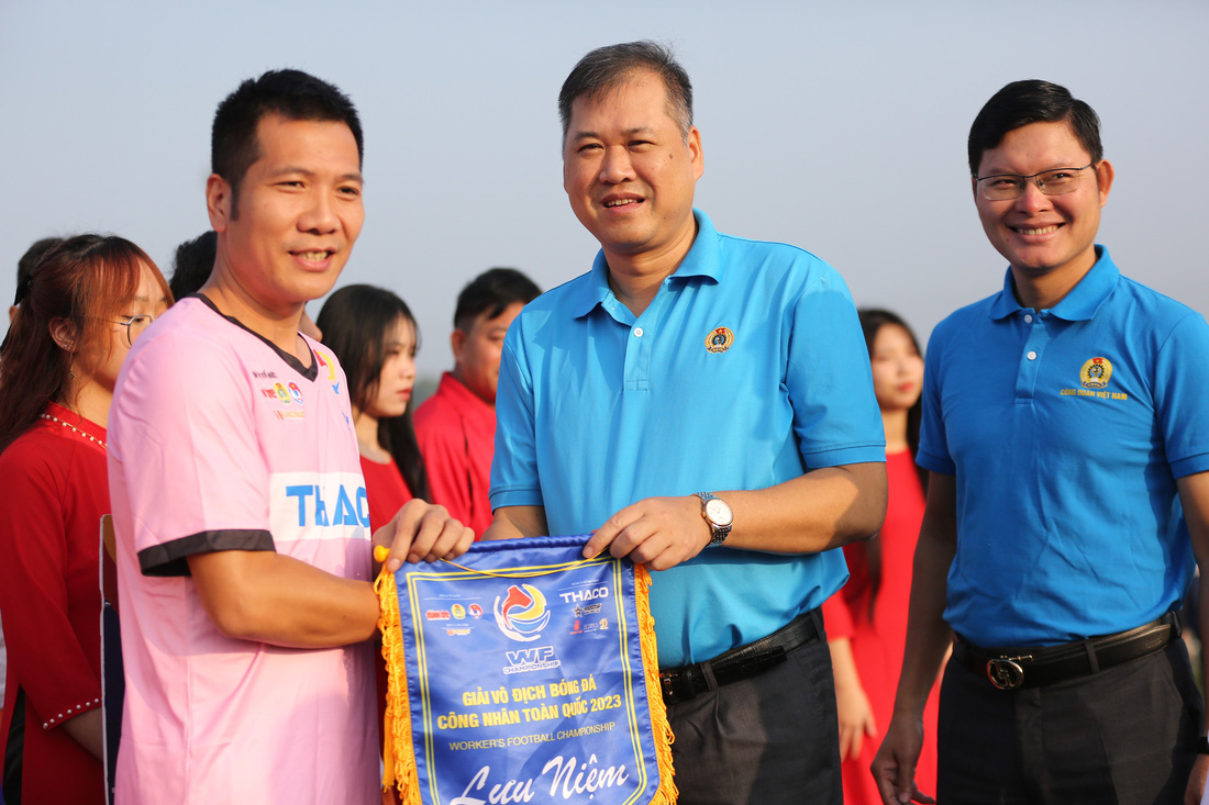 Ông Nguyễn Minh Dũng - trưởng Ban Tài chính Tổng liên đoàn Lao động Việt Nam - trao cờ lưu niệm cho các đội bóng dự giải - Ảnh: HOÀNG TÙNG