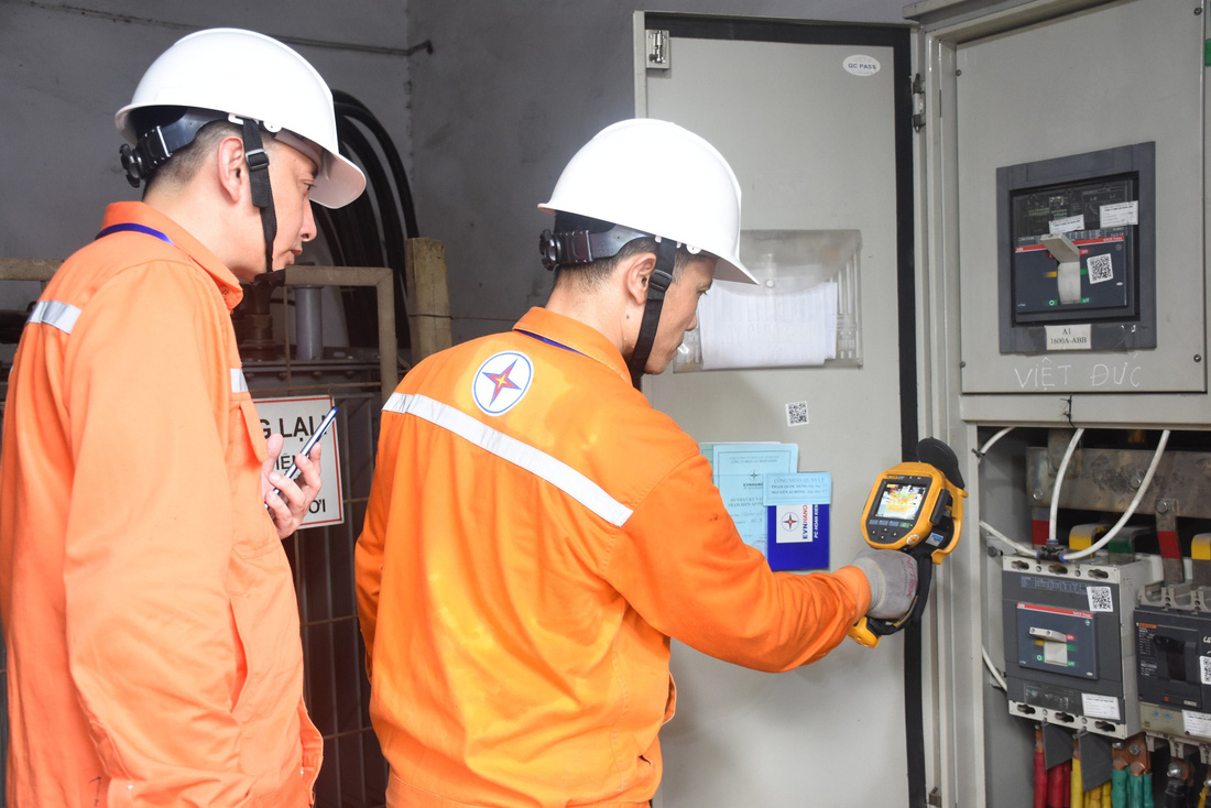 Công nhân Công ty Điện lực Hoàn Kiếm kiểm tra nhiệt độ tại trạm biến áp Trường THPT Việt Đức