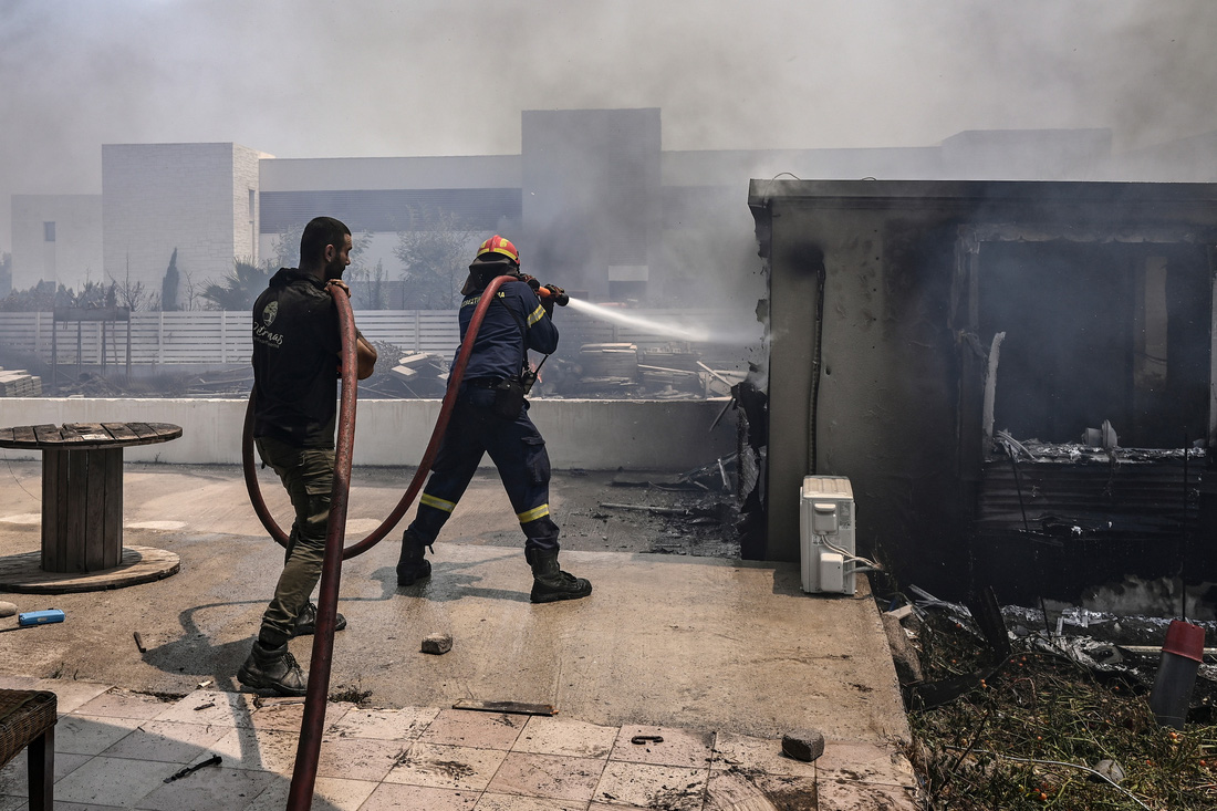 Lính cứu hỏa khống chế lửa trên đảo Rhodes hôm 24-7 - Ảnh: REUTERS 