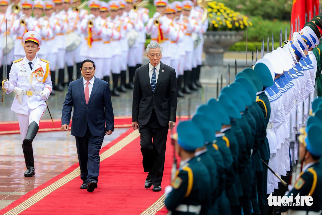 Thủ tướng Phạm Minh Chính (trái) và Thủ tướng Singapore Lý Hiển Long duyệt đội danh dự - Ảnh: NGUYỄN KHÁNH