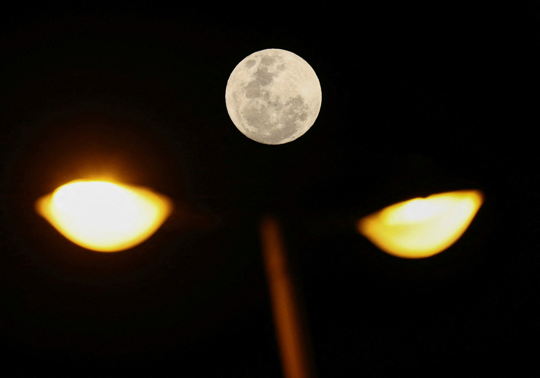 Siêu trăng xanh được chụp cùng một cột đèn đường tại thủ đô Cape Town (Nam Phi) - Ảnh: REUTERS