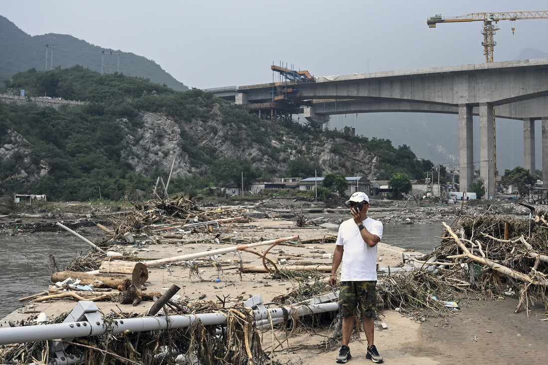 Một cây cầu bị gãy do ảnh hưởng mưa lũ - Ảnh: AFP