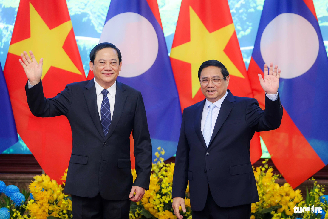 Thủ tướng Phạm Minh Chính và Thủ tướng Lào Sonexay Siphandone vẫy tay chào báo chí trước khi hội đàm - Ảnh: NGUYỄN KHÁNH