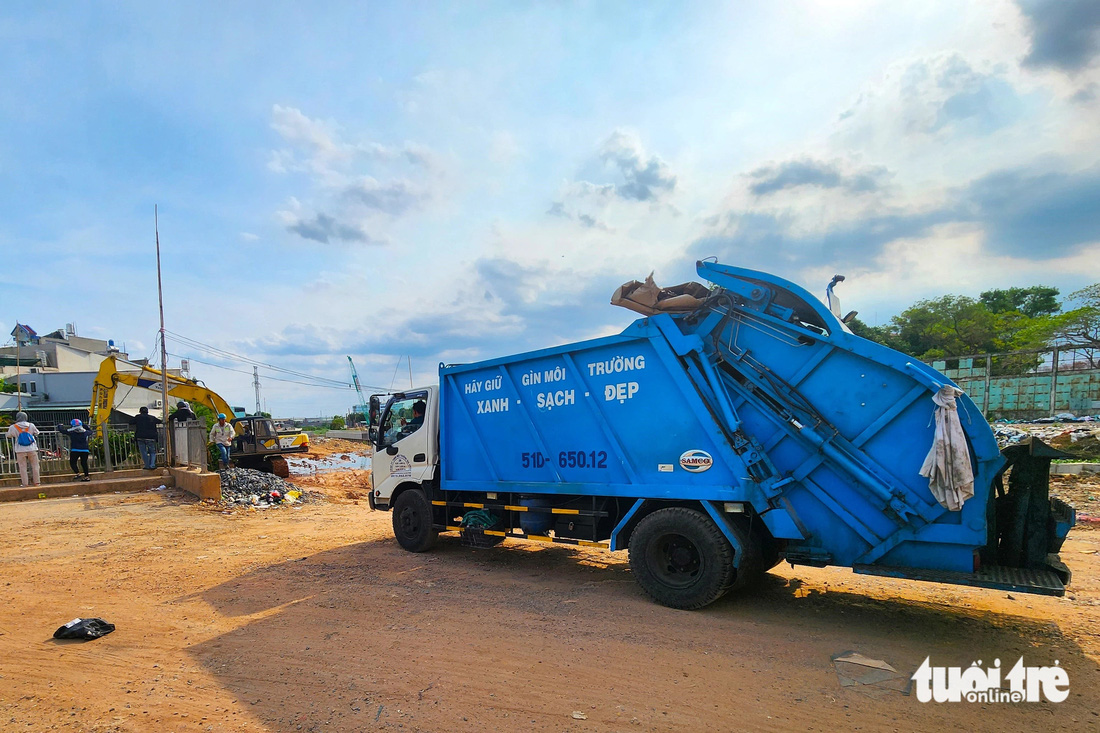 Xe gom, vận chuyển lục bình, rác thải trên kênh Nước Đen mang đi xử lý - Ảnh: NGỌC KHẢI