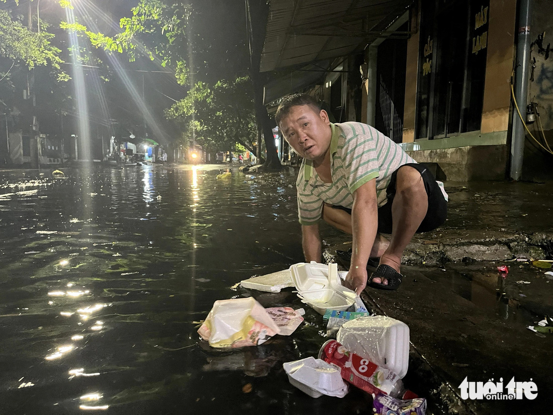 Rác thải bịt kín các miệng cống trên đường Lê Thành Phương, TP Tuy Hòa, người dân phải dùng tay móc rác khơi thông miệng cống - Ảnh: NGUYỄN HOÀNG