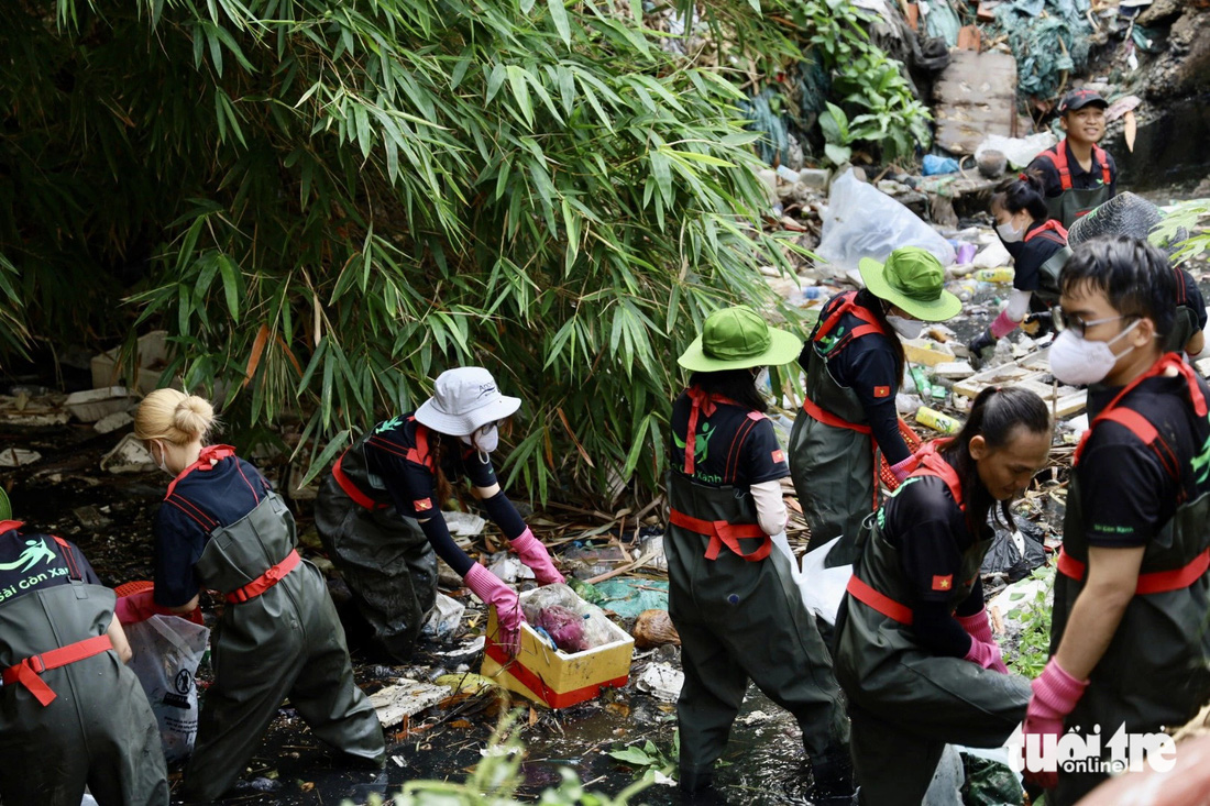 Hơn 50 tình nguyện viên ra quân giải cứu kênh thoát nước trên đường Giải Phóng, phường 4, quận Tân Bình - Ảnh: NGỌC QUÝ