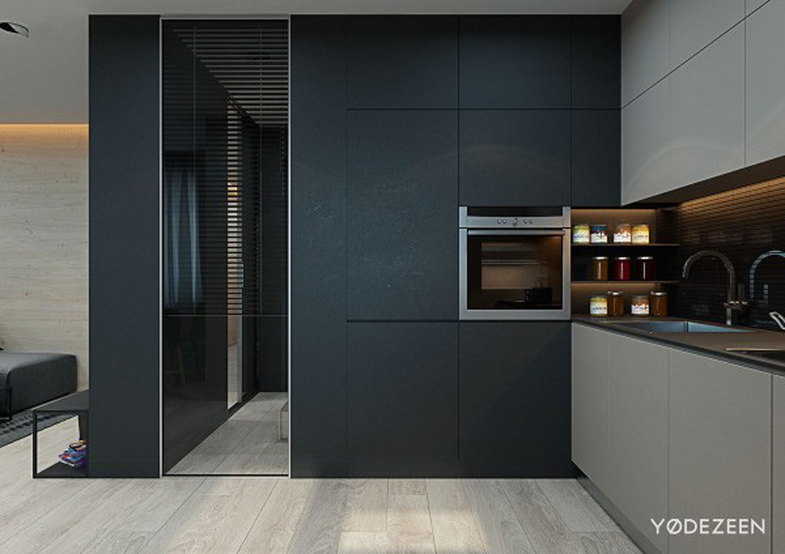 Tấm ốp màu đen và tấm gương giúp mở rộng không gian bếp - Ảnh: YØ DEZEEN