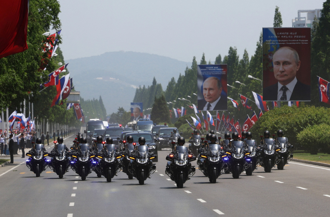  Đội mô tô dẫn đoàn xe hộ tống ông Putin ở Bình Nhưỡng. Ảnh chân dung của tổng thống Nga được đặt ở khắp các tuyến phố lớn của thành phố này - Ảnh: SPUTNIK