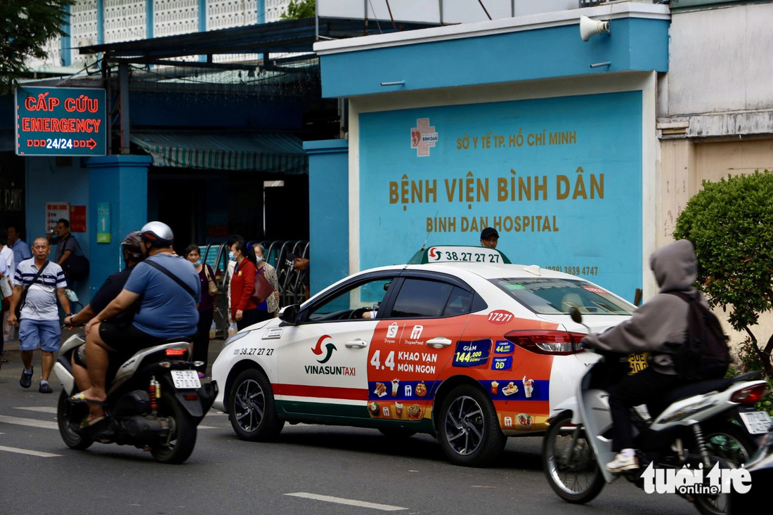 Xe taxi đậu ngay trước cổng Bệnh viện Bình Dân để đón khách - Ảnh: NGỌC QUÝ