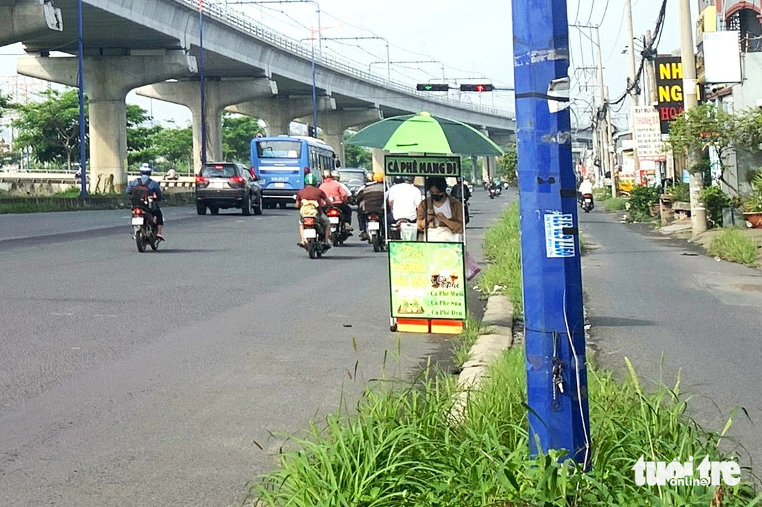 Một cột đèn bị kẻ xấu cạy phá nắp trộm thiết bị bên trong, đơn vị quản lý phải dùng băng keo để đấu nối lại - Ảnh: TIẾN QUỐC