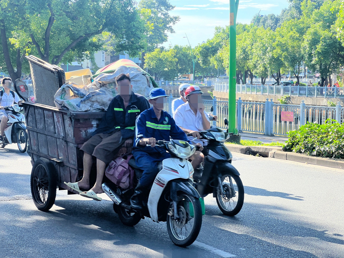 Những người ngồi trên xe rác không ai đội mũ bảo hiểm 