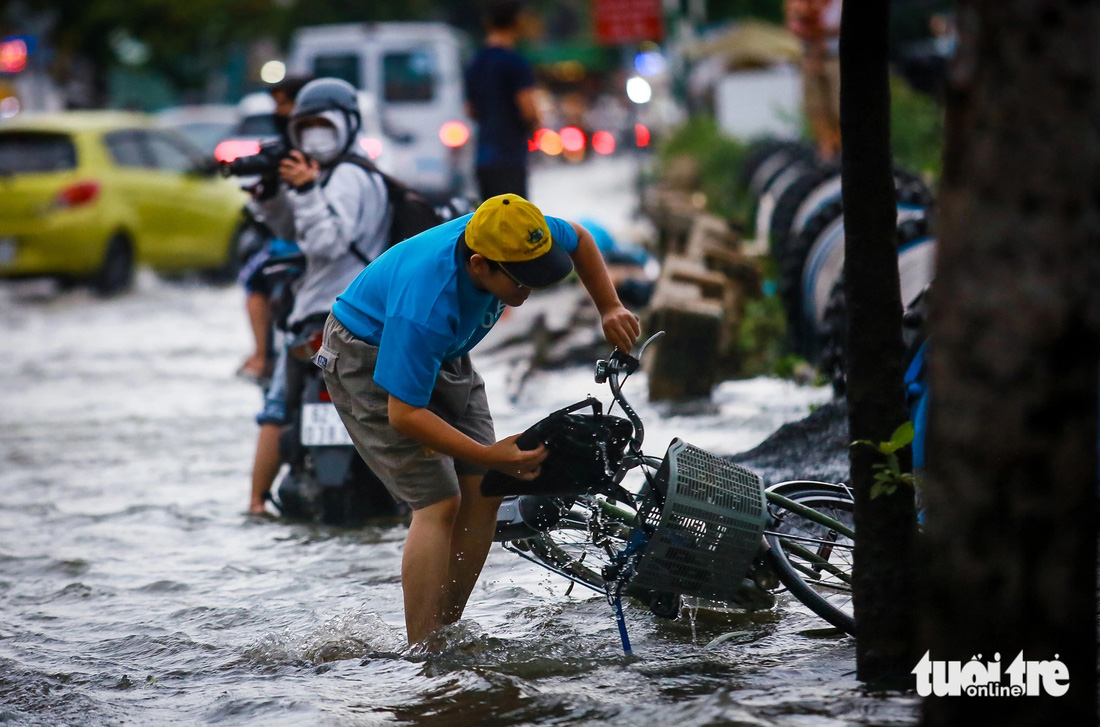 TP.HCM đón đợt triều cường đầu mùa, xe máy dắt bộ, xe hơi quay đầu - Ảnh 11.