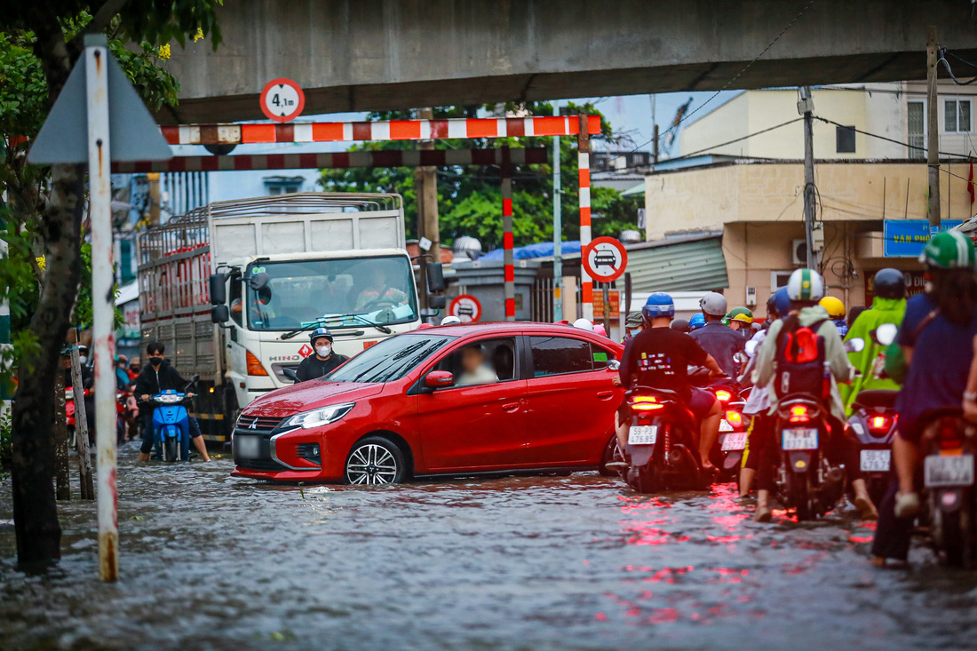 TP.HCM đón đợt triều cường đầu mùa, xe máy dắt bộ, xe hơi quay đầu - Ảnh 1.