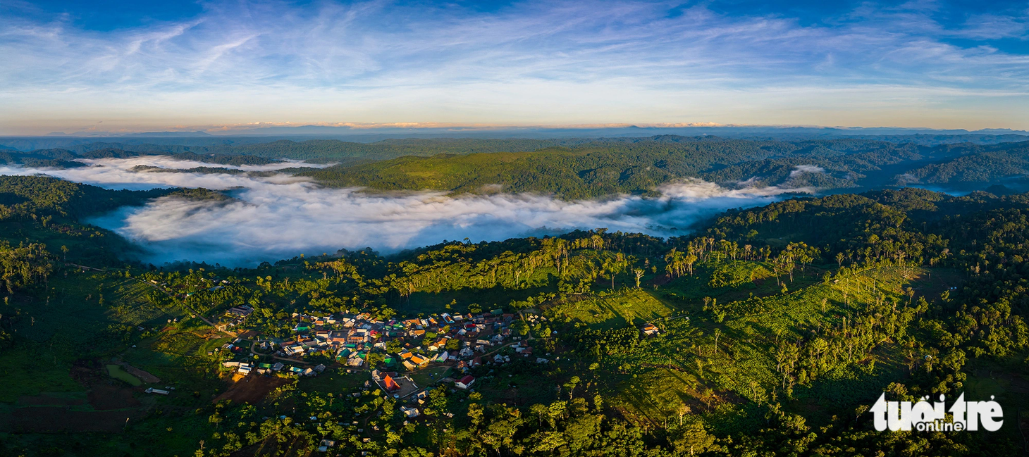 Biển mây trắng xuống thung, bao quanh là màu xanh ngát của rừng nguyên sinh, những mái nhà ngói đỏ nhỏ xinh dưới bình minh ngày mới nơi "cổng trời" An Toàn - Ảnh: DŨNG NHÂN