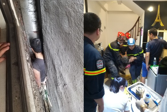 Cảnh sát giải cứu người đàn ông mắc kẹt ở khe hở giữa 3 ngôi nhà - Ảnh 1. Cảnh sát giải cứu người đàn ông mắc kẹt ở khe hở giữa 3 ngôi nhà - Ảnh 1.