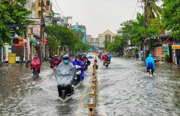 TP.HCM: Mưa như trút giờ cao điểm, dân bì bõm dắt xe chết máy qua điểm ngập - Ảnh 2.