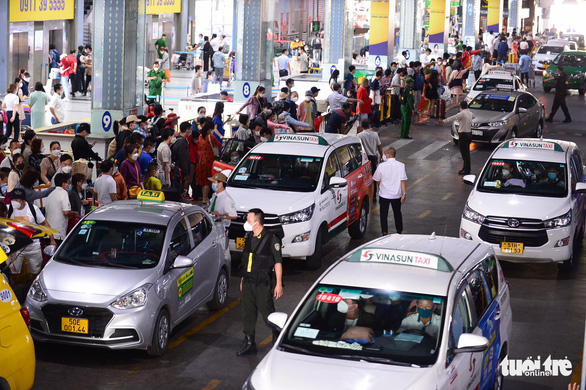 Khách đổ dồn đến Tân Sơn Nhất, sảnh chờ đón taxi đông nghẹt - Ảnh 7.