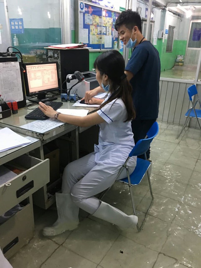 Nước tràn vào bệnh viện, nhân viên y tế đi ủng - Ảnh 3.