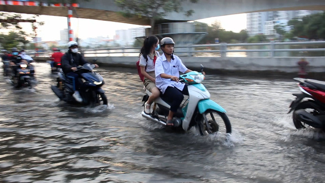 Các bạn thường chuẩn bị sẵn dép để dùng vào những ngày triều cường - Ảnh: THẢO NGỌC