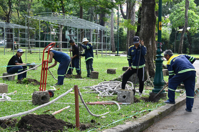 Các công nhân đang hoàn thiện những công đoạn cuối cùng, chuẩn bị cho hội hoa xuân Tao Đàn lần thứ 45.- Ảnh: N.H