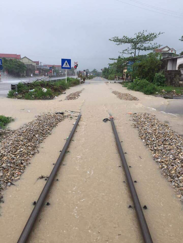 Mưa ngập đường ray, hai tàu khách chậm 3 giờ - Ảnh 1.