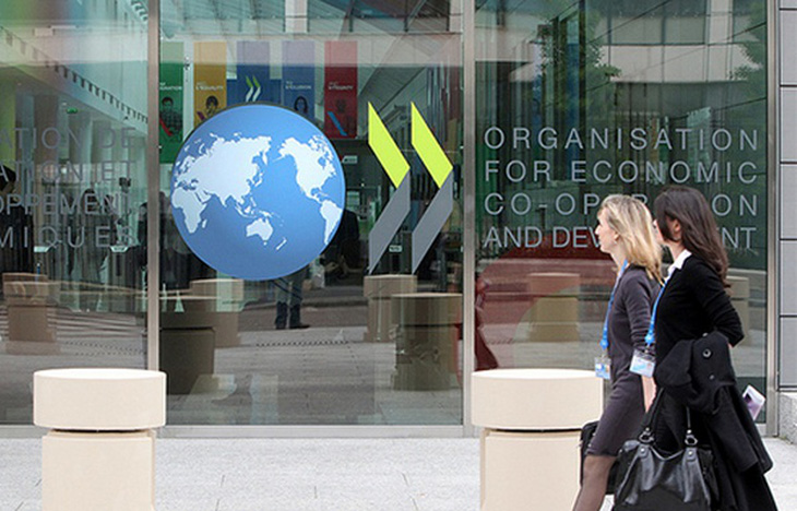 OECD cảnh báo đà phục hồi kinh tế toàn cầu không chắc chắn - Ảnh 1.