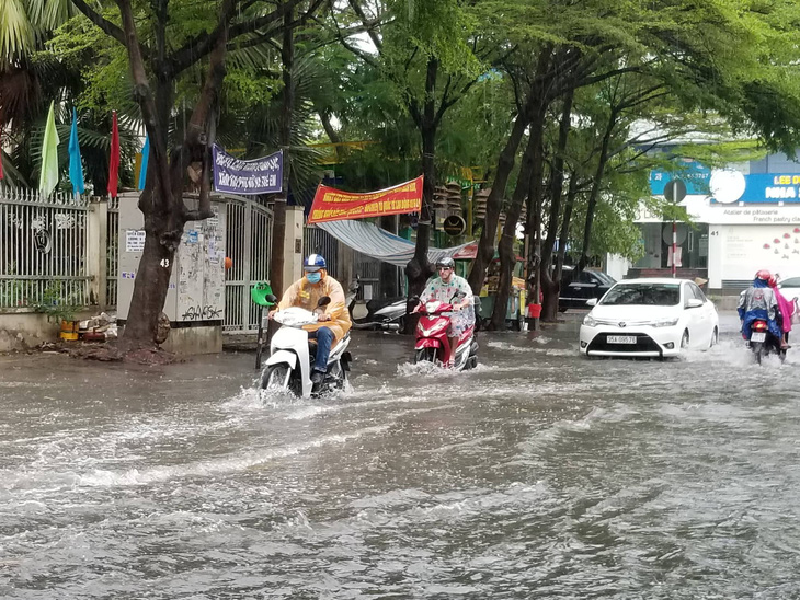 Chiều chủ nhật mưa rơi, người dân TP.HCM lại bì bõm lội nước - Ảnh 1.