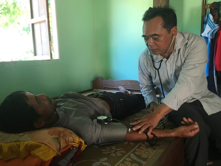 Ông bí thư huyện Mấu Văn Phi chạy xe máy cà tàng khám bệnh cho bà con - Ảnh 1.