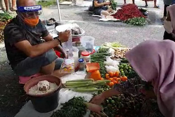 Quan chức Indonesia giả làm người bán rau để dạy dân giữ giãn cách xã hội - Ảnh 1.