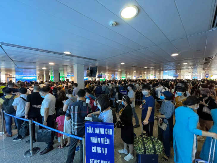 Sân bay Tân Sơn Nhất đông nghẹt, khách xếp hàng suýt lỡ chuyến - Ảnh 3.
