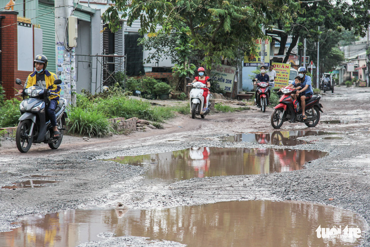 Đường dẫn vào làng đại học xuống cấp trầm trọng với hàng trăm ‘hố bom’ - Ảnh 1.