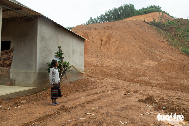 Nhà bà Hồ Thị Năm bị bùn đất vùi lấp 50cm do nằm sát một bãi thải cao hàng chục mét - Ảnh: HOÀNG TÁO